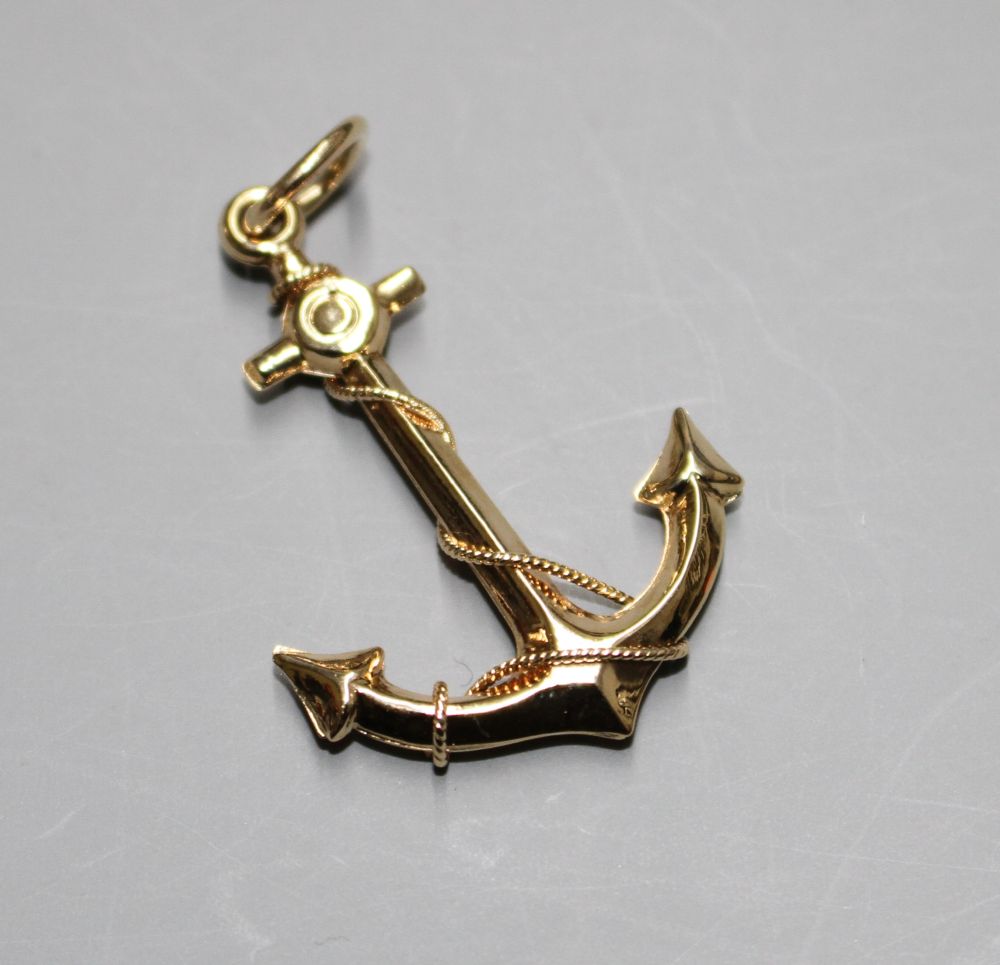 A yellow metal pendant, modelled as an anchor,